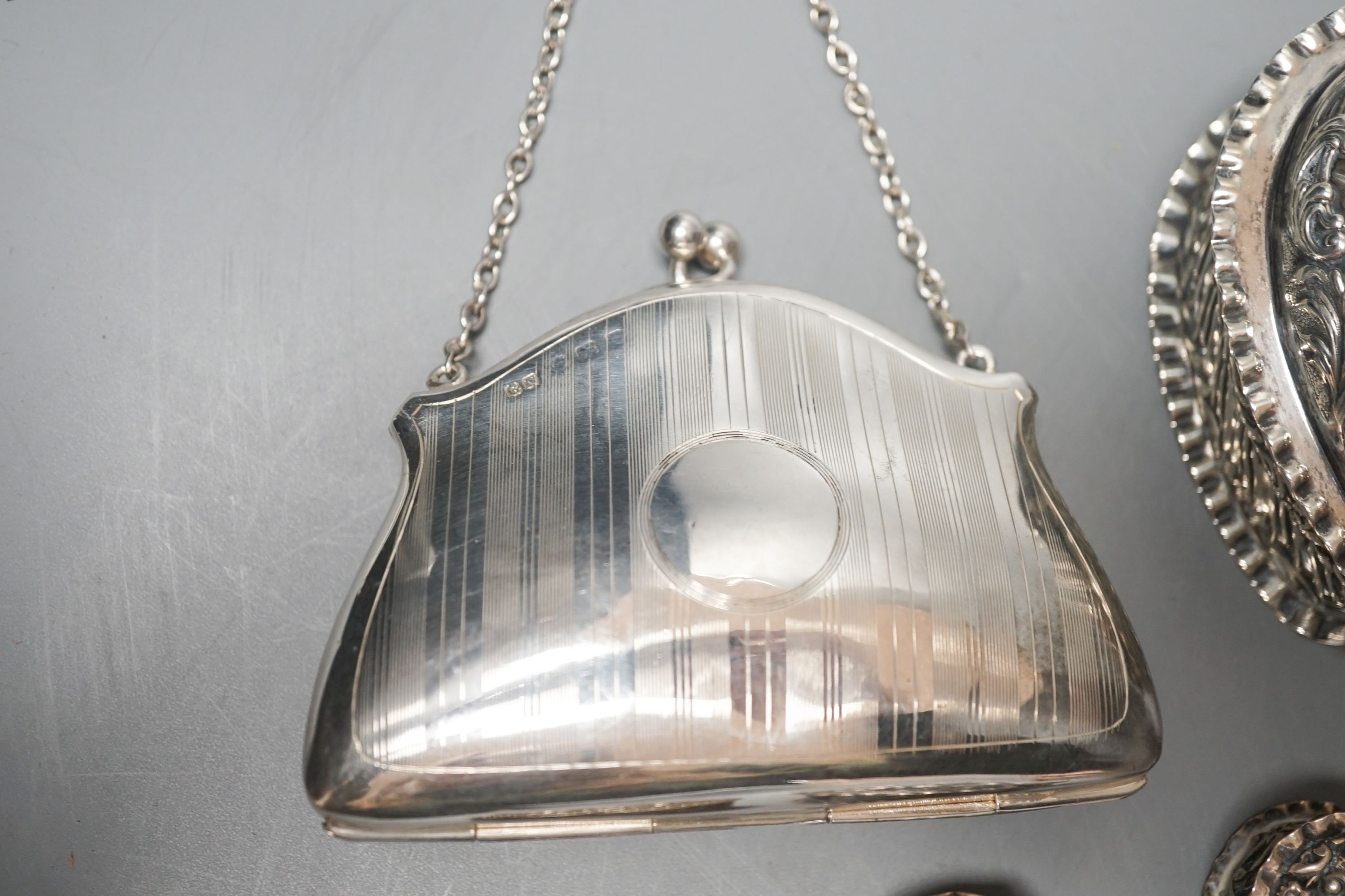 Four assorted silver or white metal heart shaped trinket boxes, largest 85mm a silver pin cushion and a silver purse.